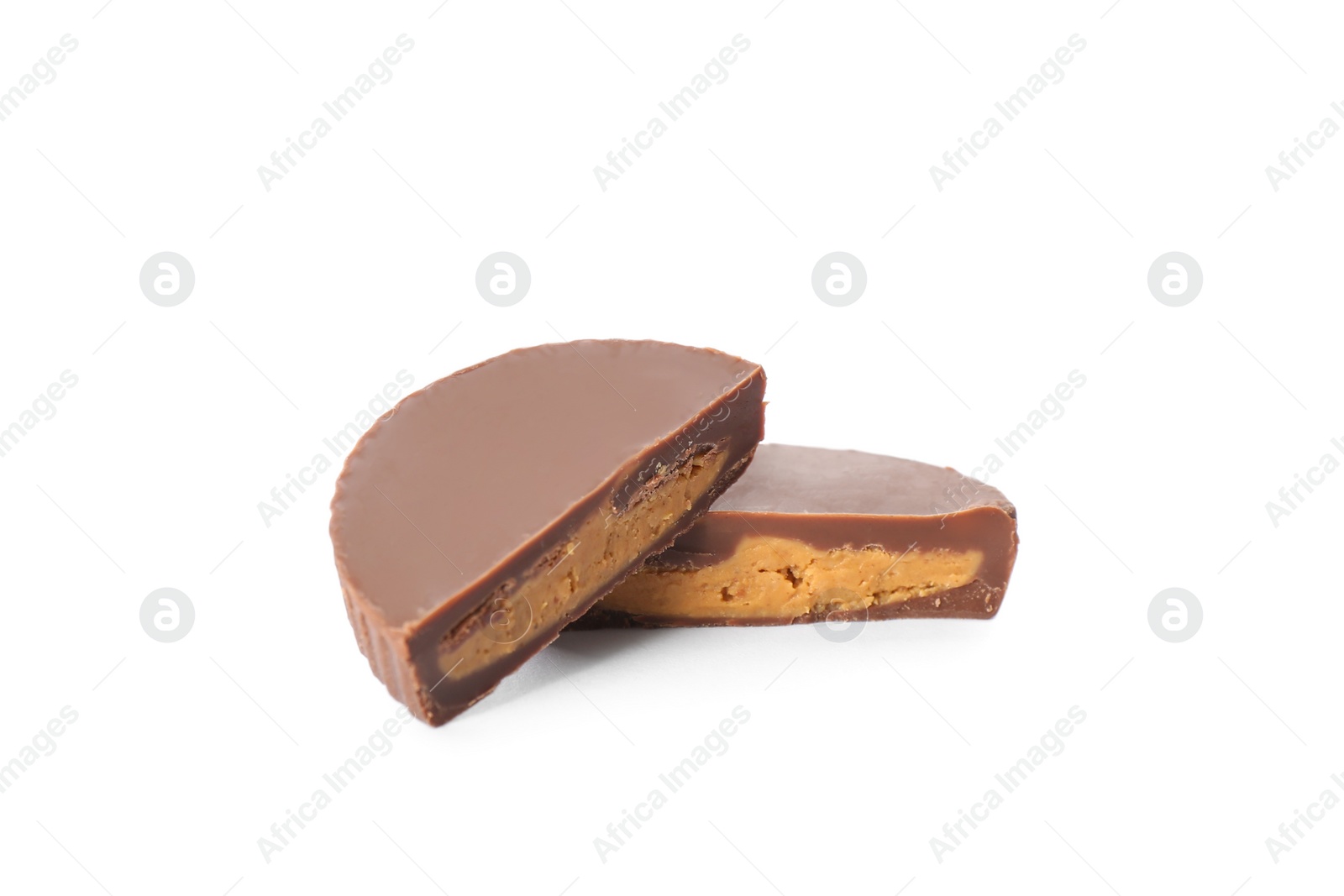 Photo of Cut delicious peanut butter cup on white background