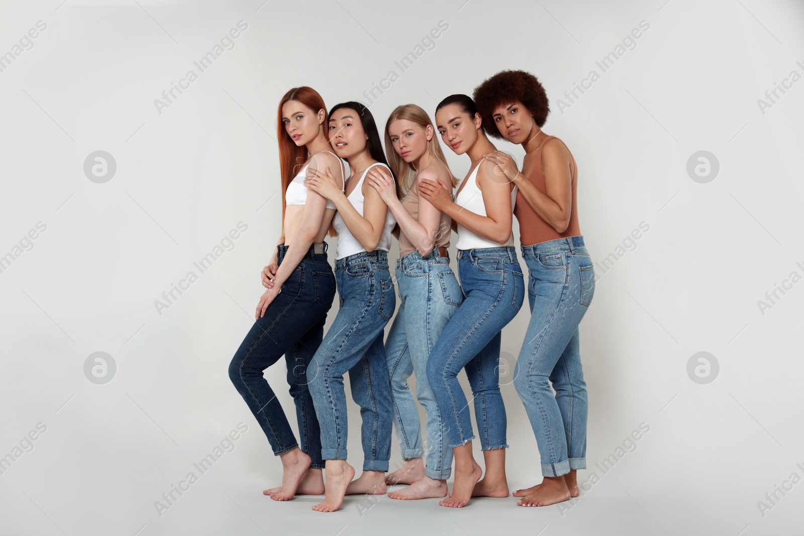 Photo of Group of beautiful young women on light grey background