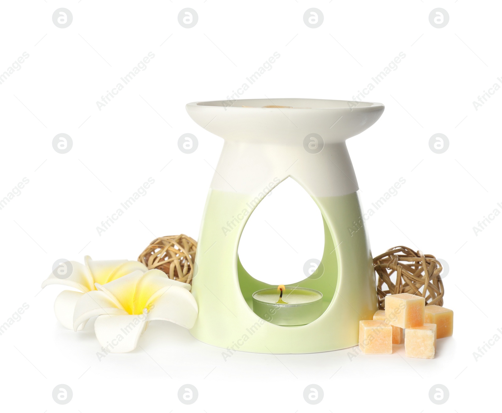 Photo of Stylish aroma lamp with essential wax cubes and flowers on white background