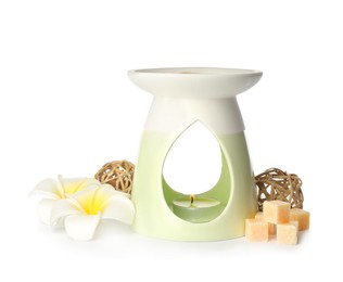 Stylish aroma lamp with essential wax cubes and flowers on white background