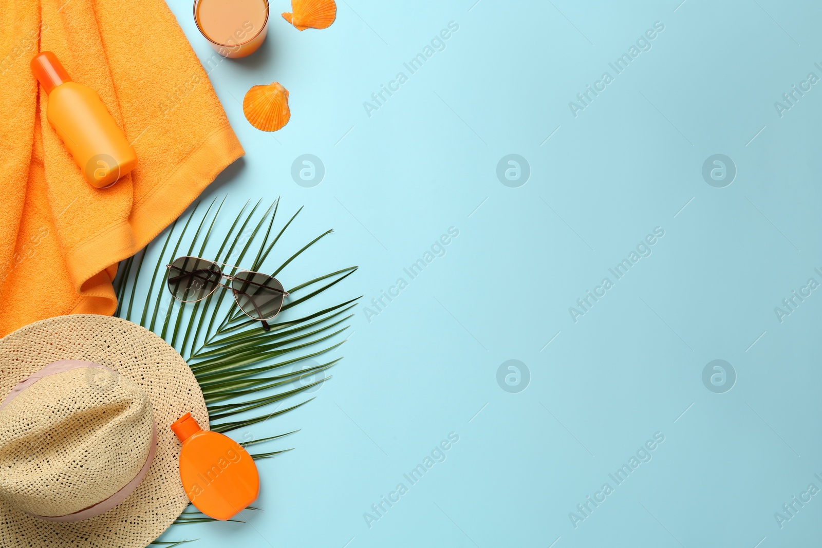 Photo of Flat lay composition with different beach objects on light blue background, space for text