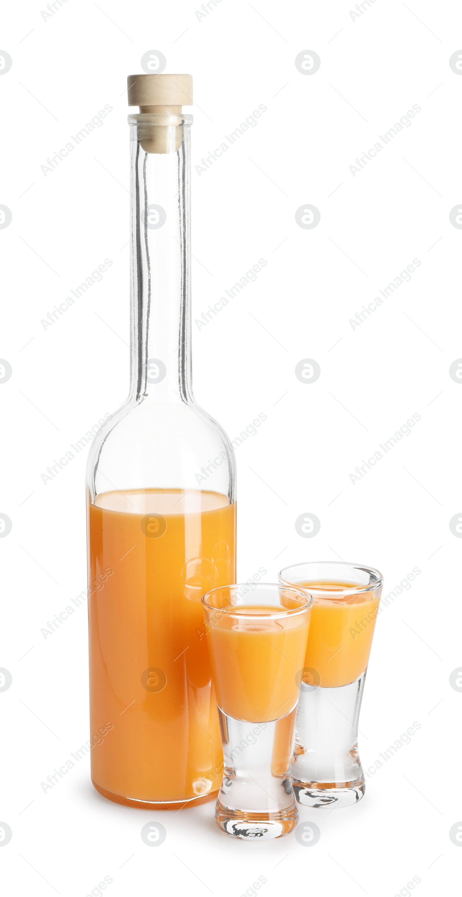 Photo of Bottle and shot glasses with tasty tangerine liqueur isolated on white