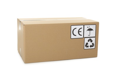 Photo of Cardboard box with different packaging symbols isolated on white. Parcel delivery