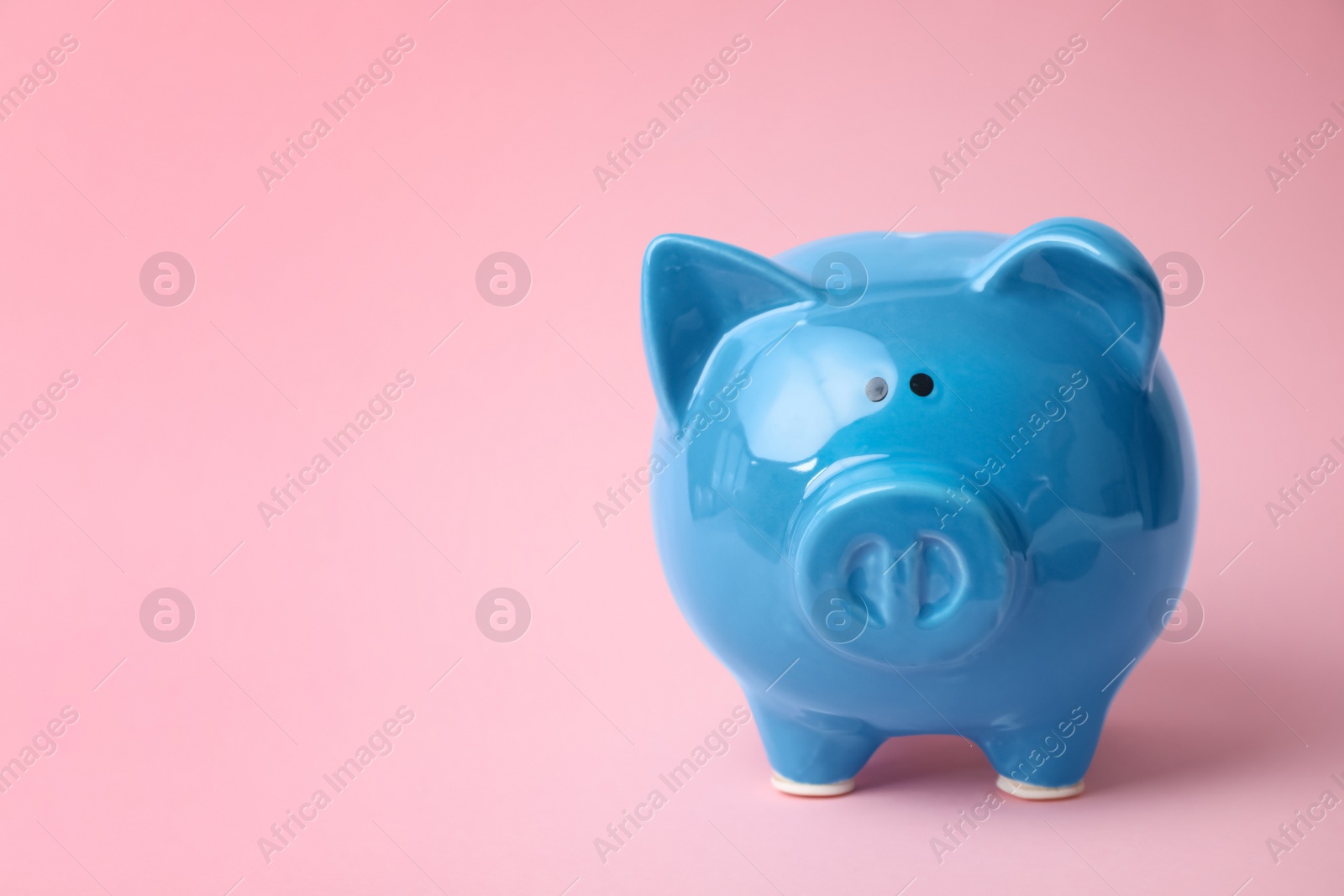 Photo of Blue piggy bank on color background. Money saving