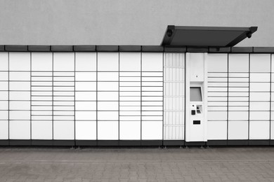 Photo of Modern parcel locker with many postal boxes outdoors