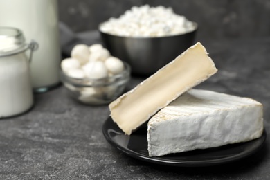 Photo of Plate with fresh brie cheese on table. Dairy products