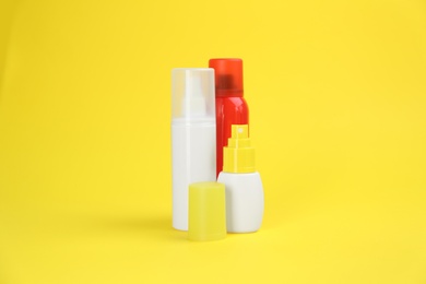 Photo of Set of different insect repellents on yellow background