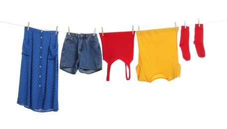 Photo of Different clothes drying on laundry line against white background