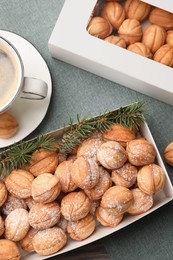 Box with delicious nut shaped cookies on table, flat lay