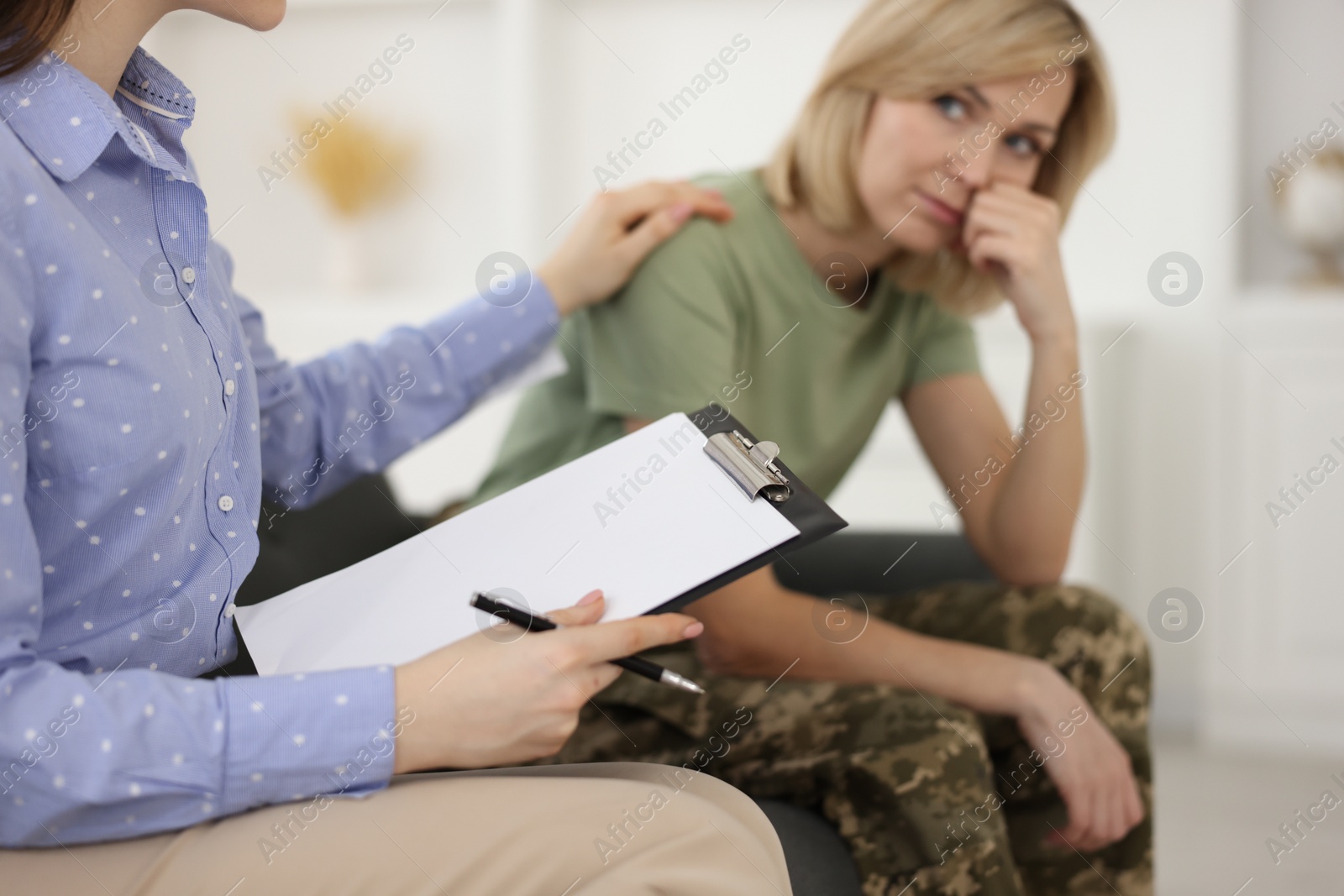 Photo of Psychotherapist working with military woman in office