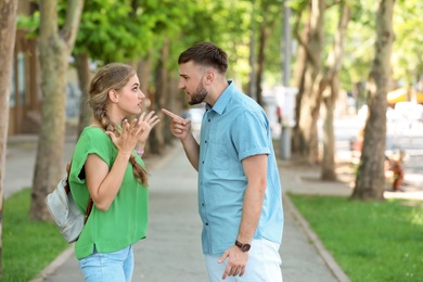 Young couple arguing on street. Problems in relationship