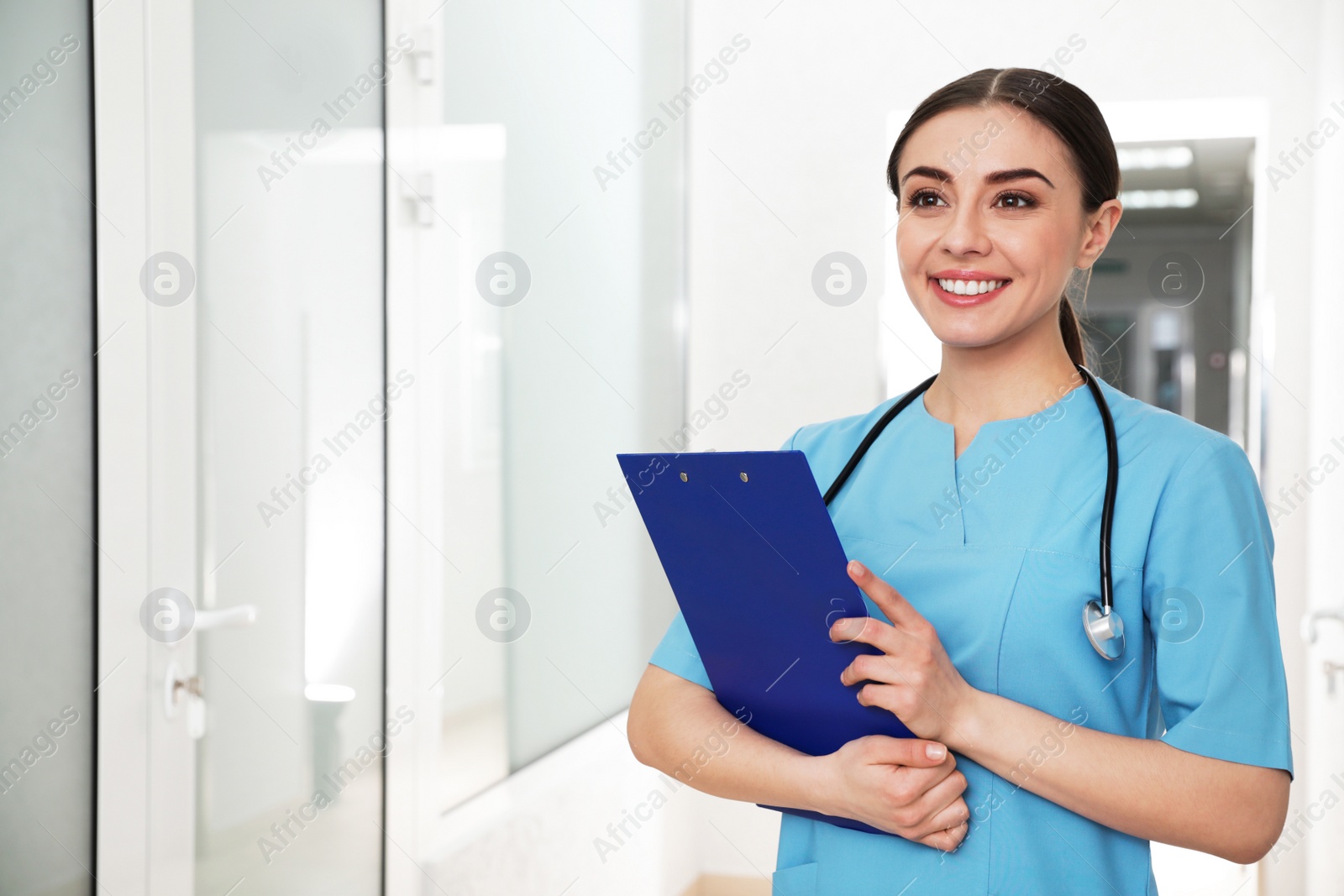 Photo of Portrait of nurse with clipboard in hospital hallway. Medical assisting