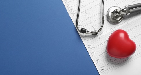 Photo of Cardiogram report, red decorative heart and stethoscope on blue background, flat lay with space for text