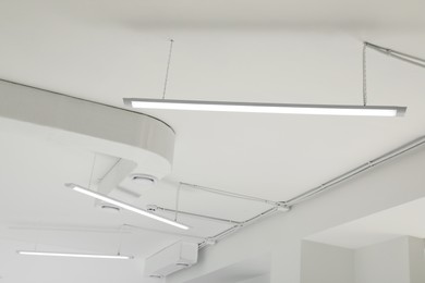Photo of White ceiling with modern lighting in room