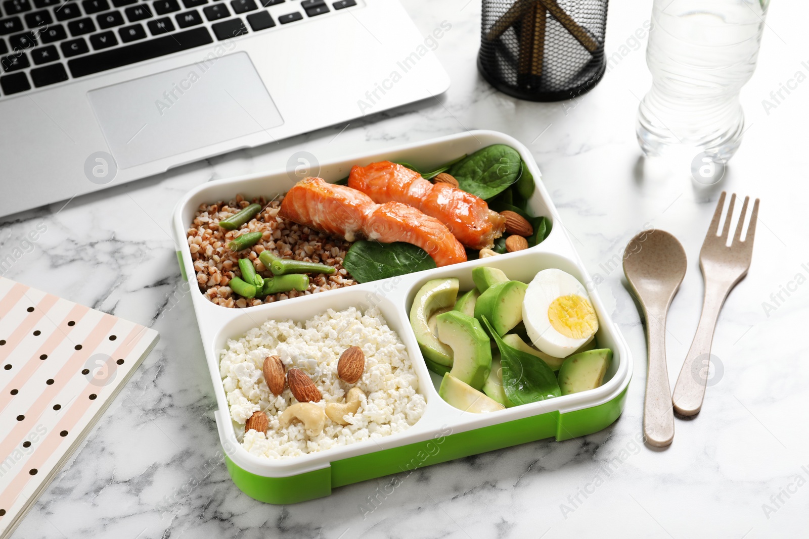 Photo of Container with natural protein food on office table