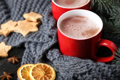 Composition with cups of tasty cocoa on table