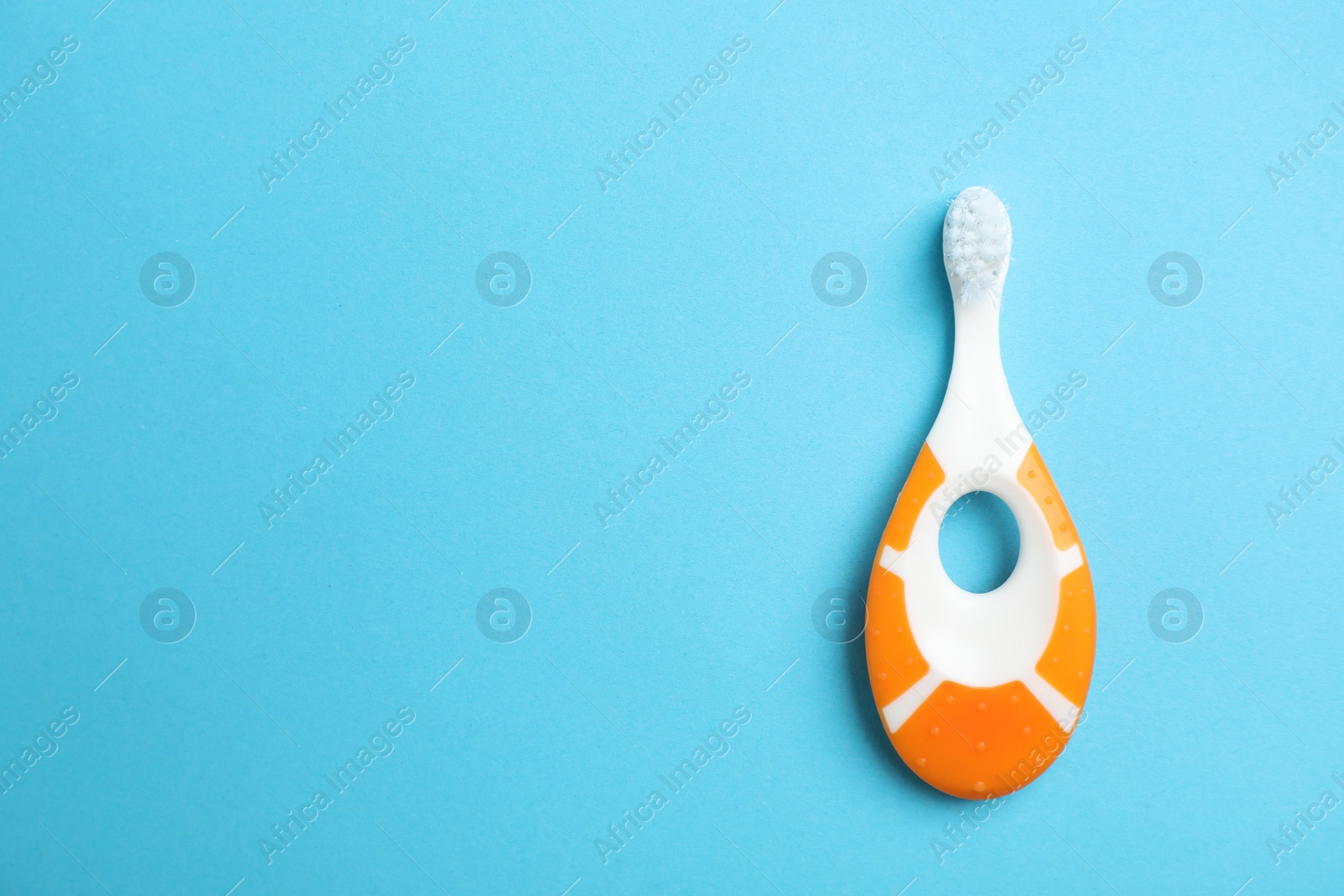 Photo of Manual toothbrush for child on color background, top view with space for text