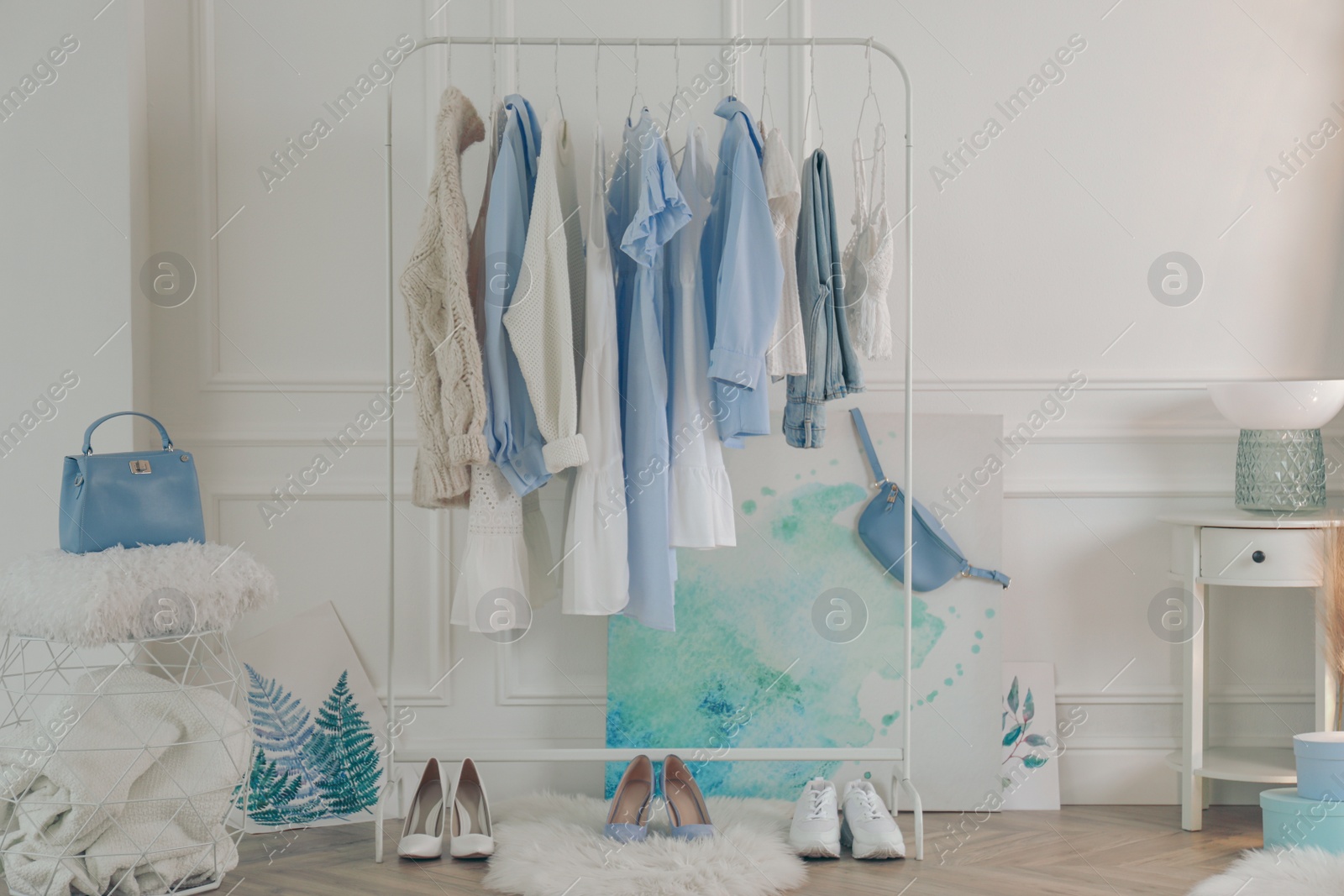 Photo of Rack with stylish clothes in modern dressing room