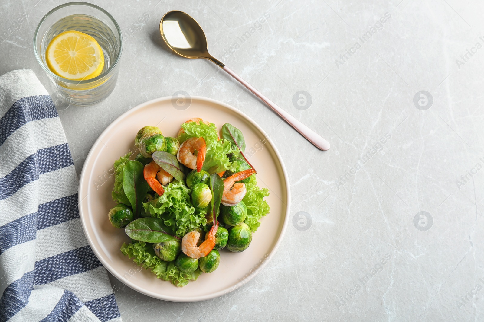 Photo of Tasty salad with Brussels sprouts served on light grey table, flat lay