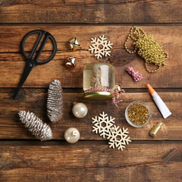 Photo of Set of instruments and materials for snow globe on wooden table, flat lay. Space for text