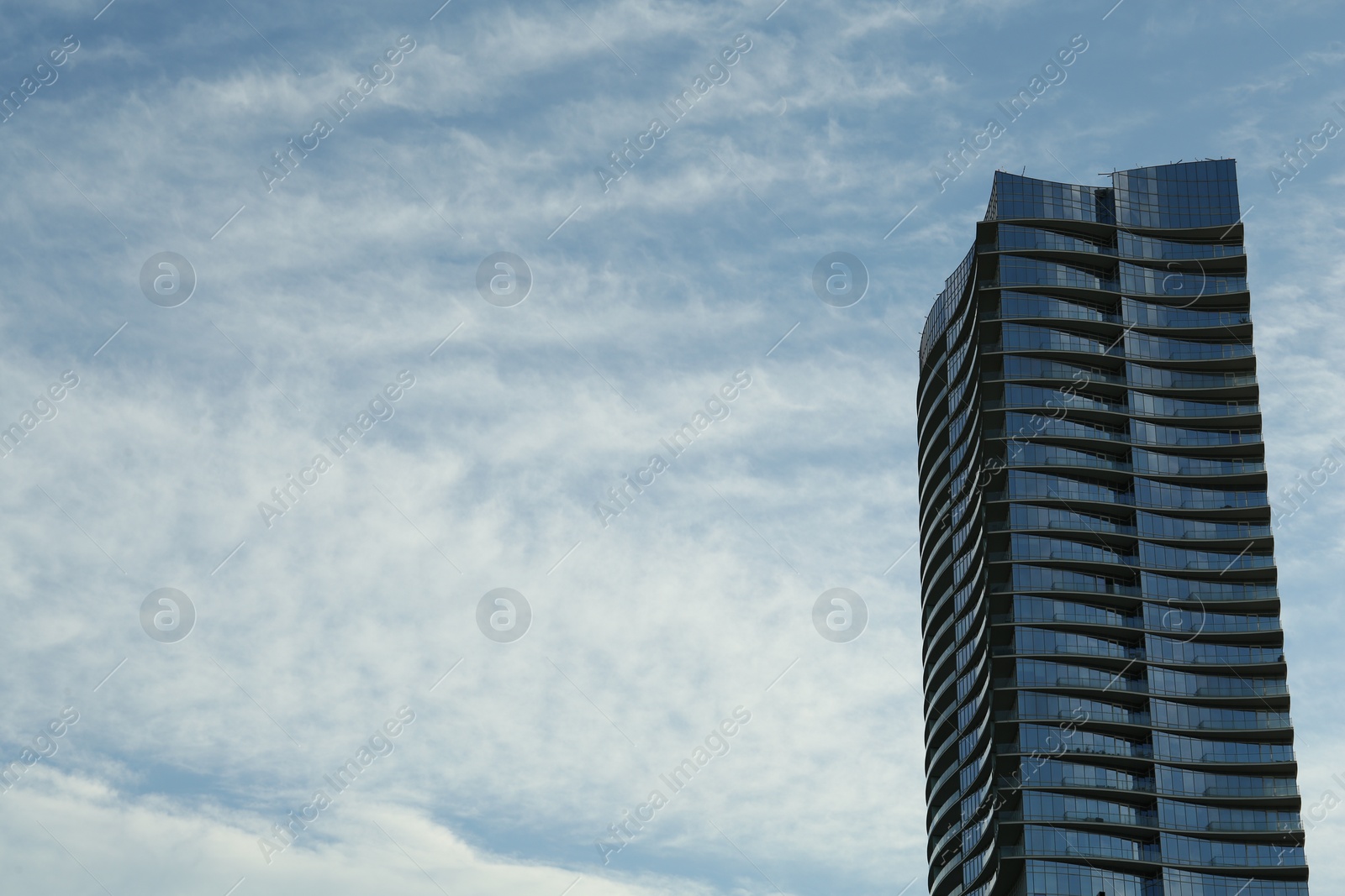 Photo of Exterior of modern building against blue sky, space for text