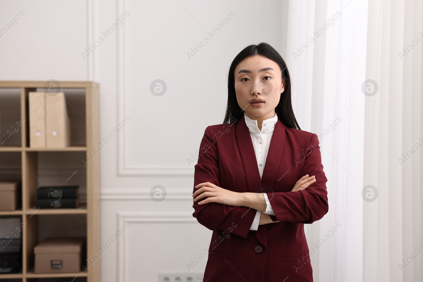 Photo of Portrait of notary with crossed arms in office. Space for text
