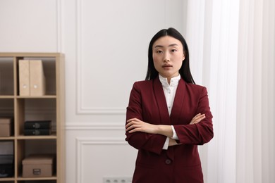 Portrait of notary with crossed arms in office. Space for text