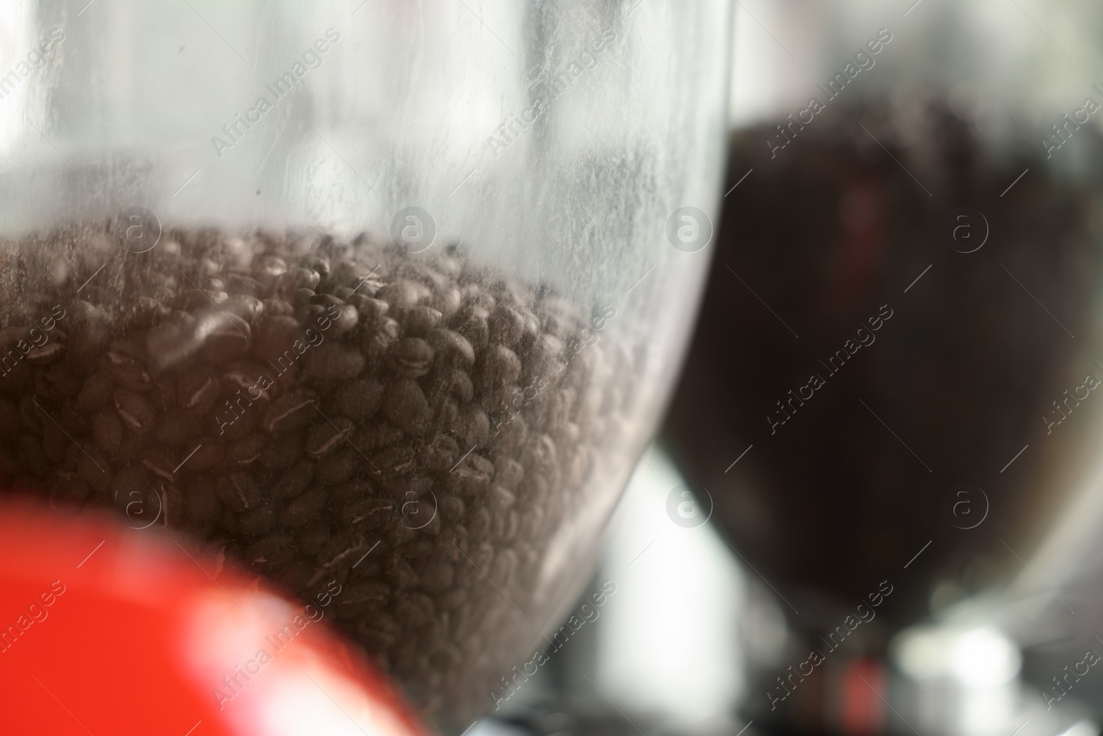 Photo of Coffee beans in modern coffee machine, closeup