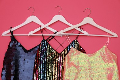 Photo of Collection of women's garments on pink background, flat lay. Clothes rent concept
