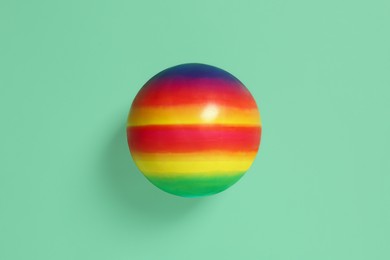 Photo of New bright kids' ball on green background, top view