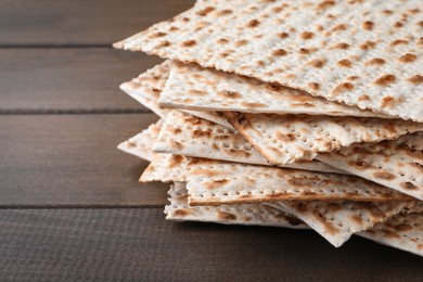 Photo of Stack of matzos on wooden table, closeup