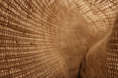 Photo of Texture of natural burlap fabric as background, closeup