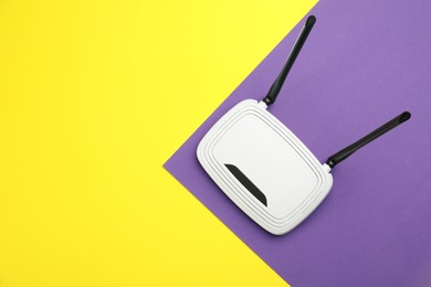 Modern Wi-Fi router on color background, top view. Space for text