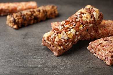 Photo of Tasty protein bars on grey table. Space for text