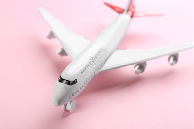 Photo of Toy airplane on pink background, closeup view