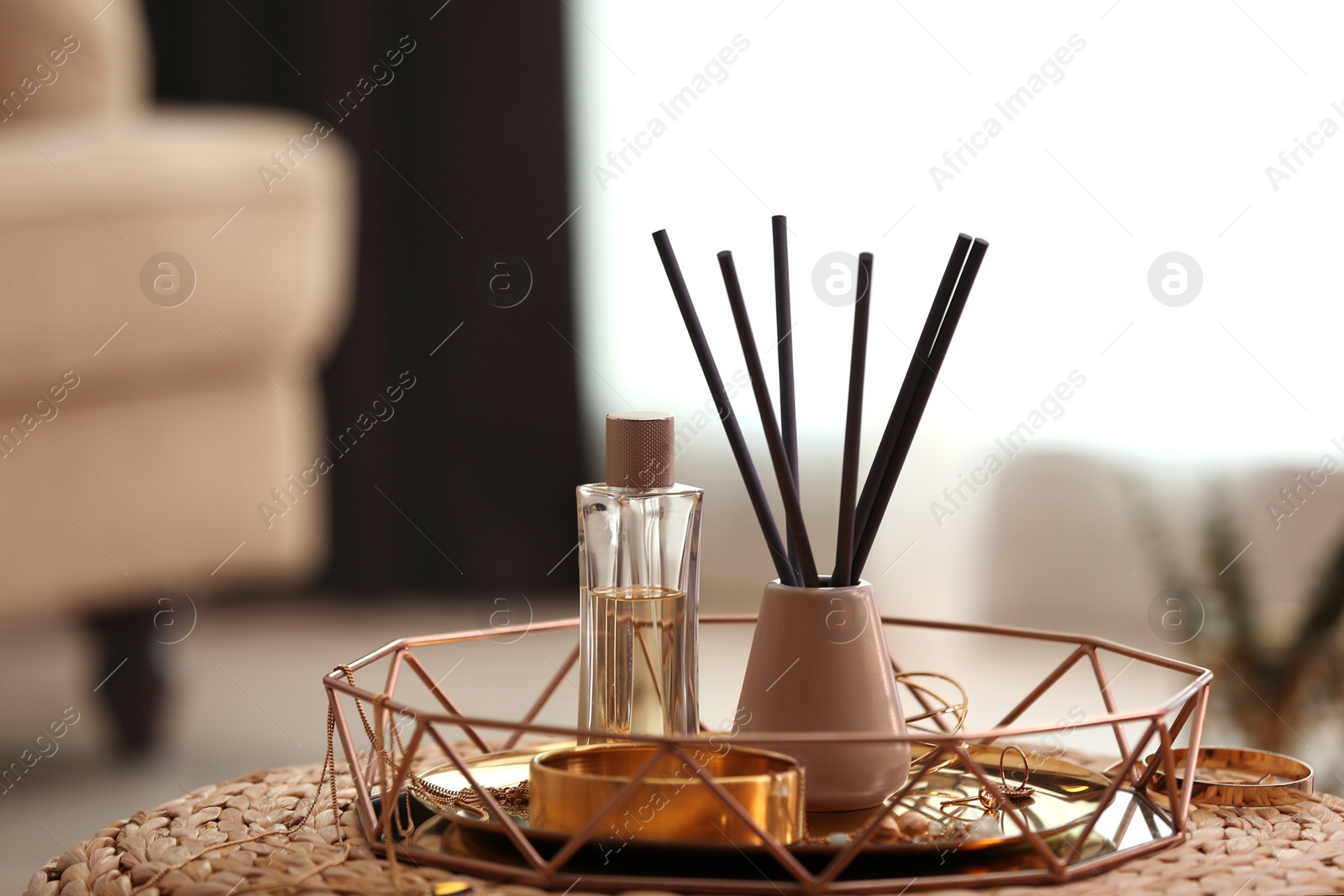 Photo of Composition with stylish accessories and interior elements on wicker pouf indoors