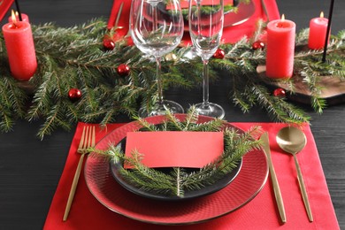 Photo of Elegant Christmas place setting with blank card and festive decor on table