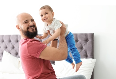 Photo of Dad and his little son spending time together at home