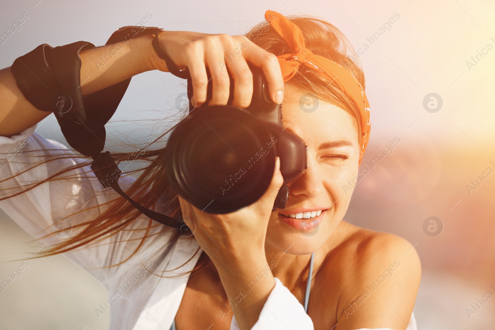 Image of Photographer taking photo with professional camera near sea