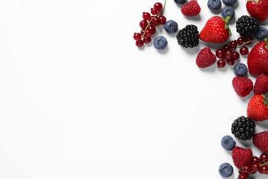 Photo of Many different fresh berries on white background, flat lay. Space for text