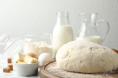 Photo of Fresh dough for pastries on white marble table