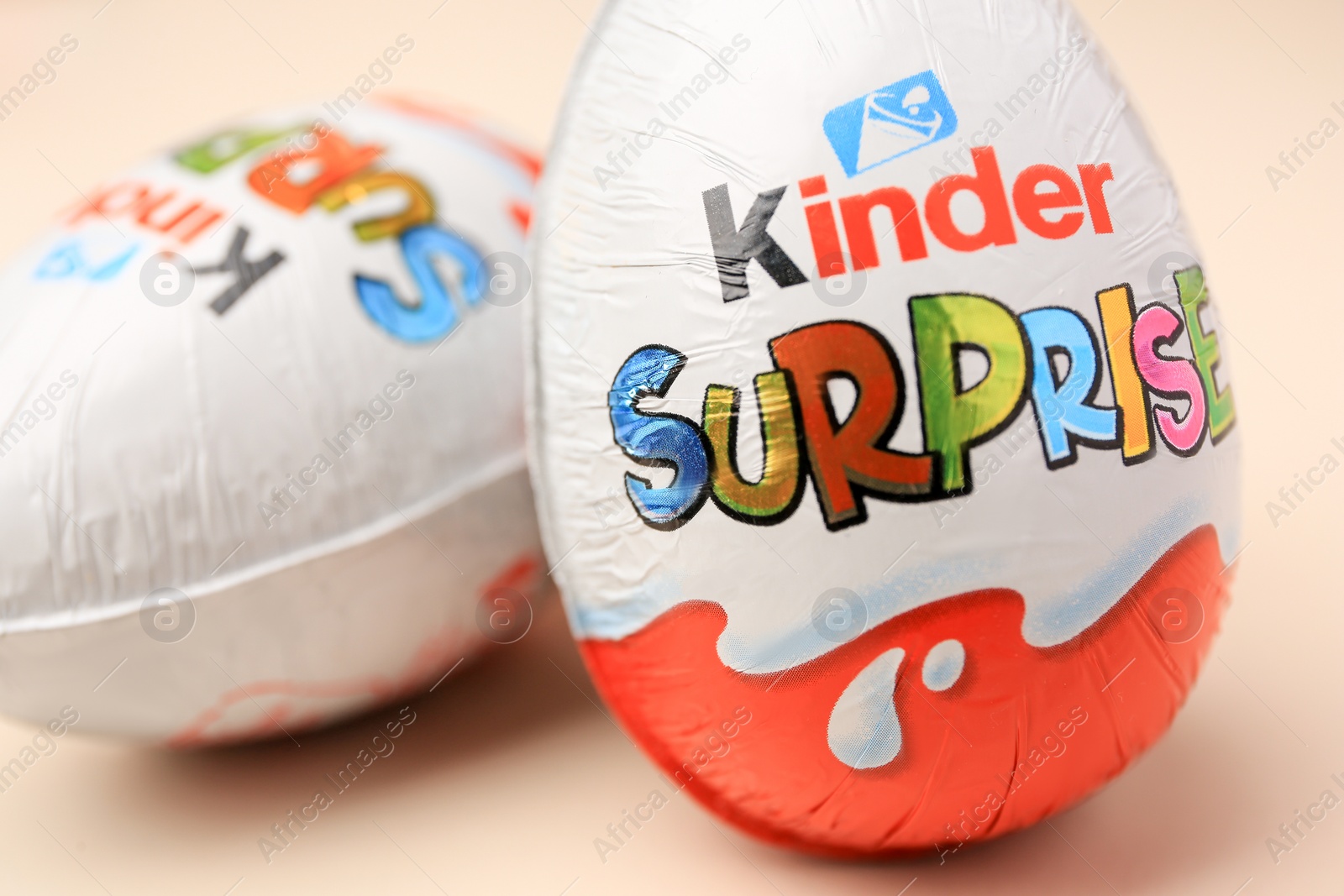 Photo of Slynchev Bryag, Bulgaria - May 25, 2023: Kinder Surprise Eggs on beige background, closeup