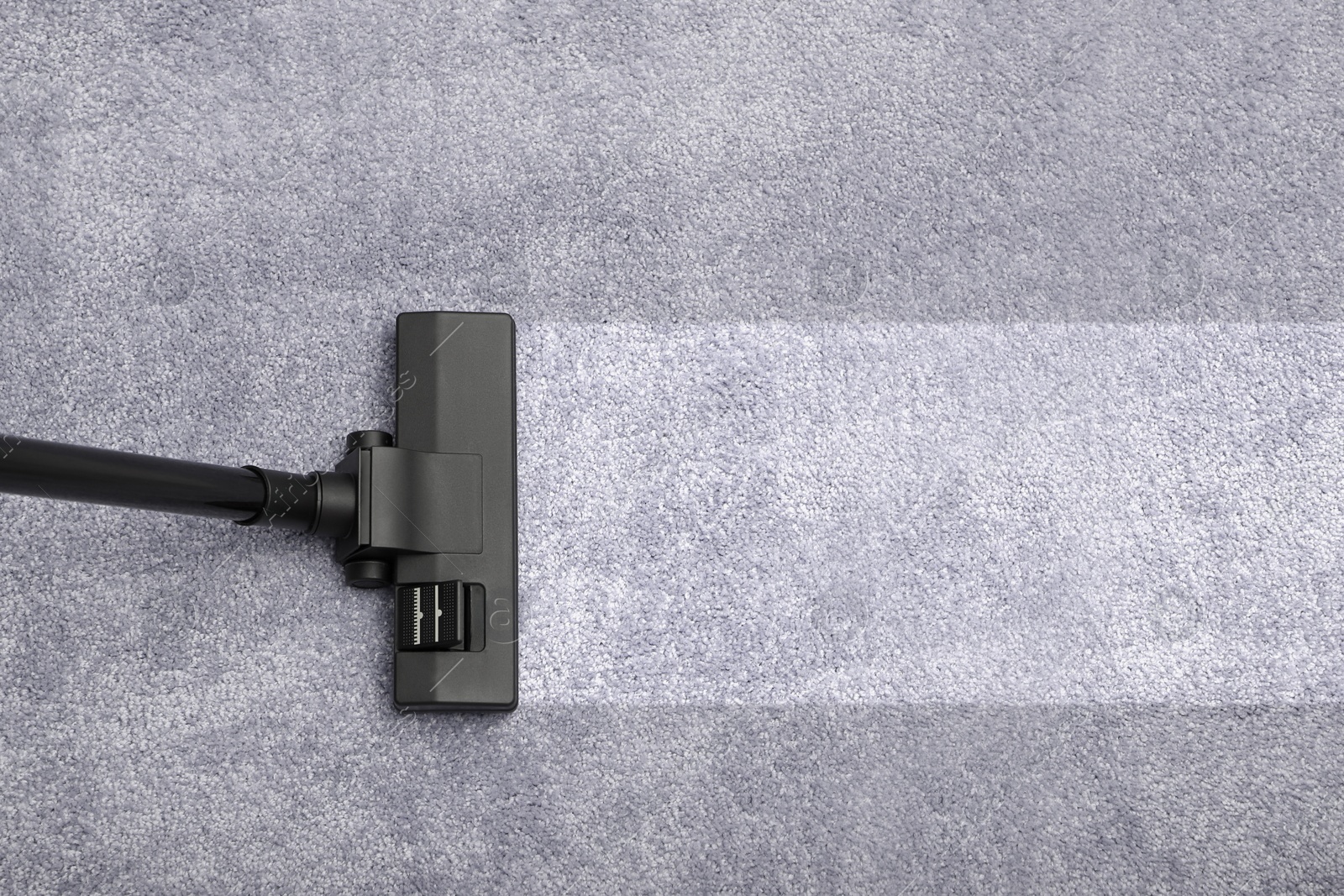 Image of Vacuuming carpet. Clean area after using device, top view