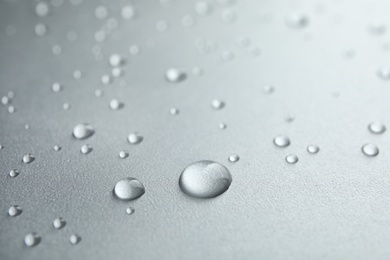 Many clean water drops on grey background