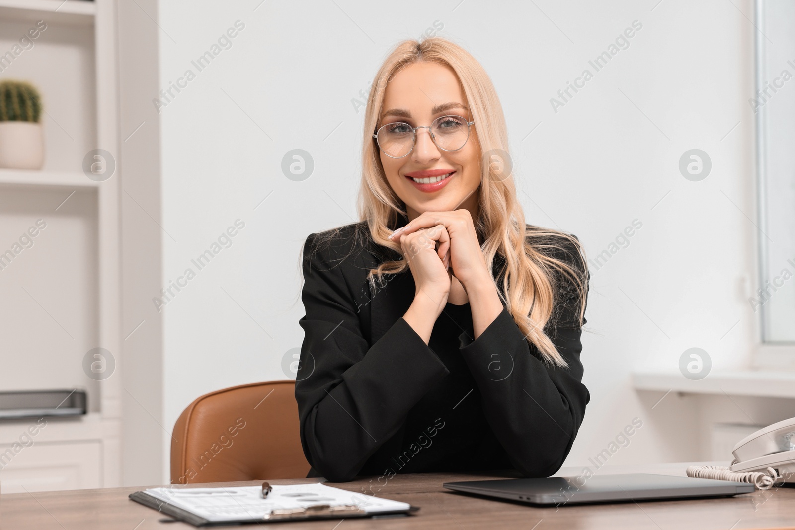 Photo of Happy secretary in glasses at table in office