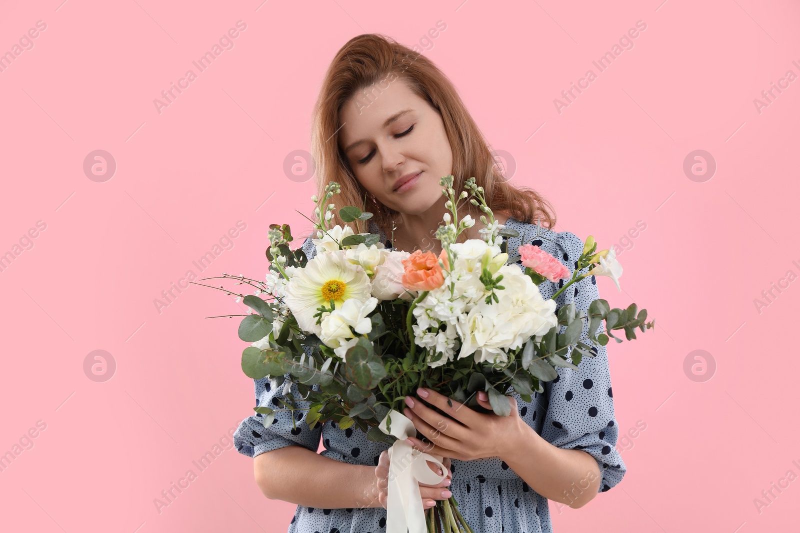 Photo of Beautiful woman with bouquet of flowers on pink background