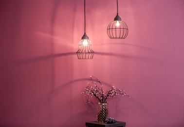 Room interior with elegant lamps and small table