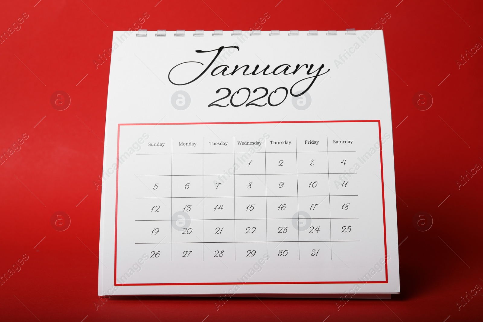 Photo of Paper calendar on red background. Planning concept