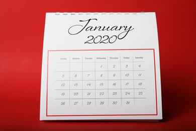 Photo of Paper calendar on red background. Planning concept