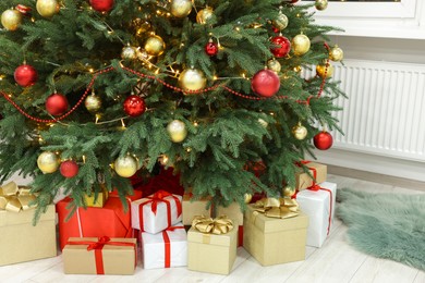 Beautiful Christmas tree and many gifts indoors
